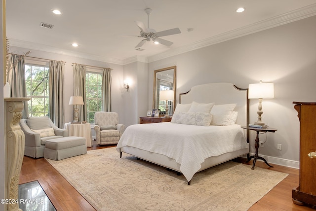 bedroom with ornamental molding, wood-type flooring, and ceiling fan