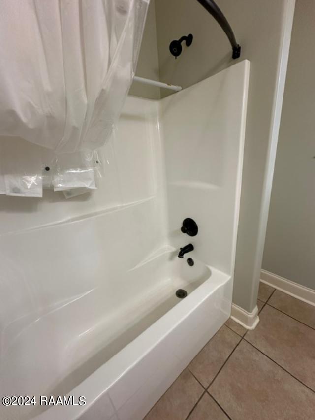 bathroom featuring tile patterned flooring and tub / shower combination