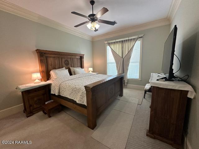 bedroom with light carpet, baseboards, a ceiling fan, and crown molding