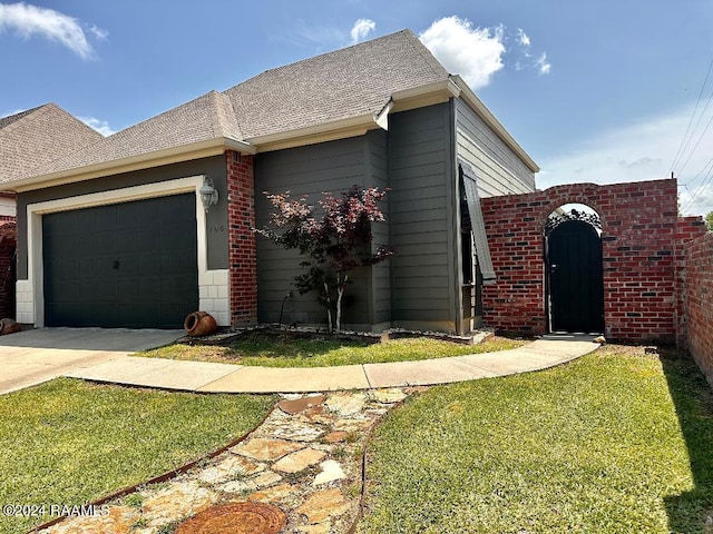 view of front of home with a garage and a front yard