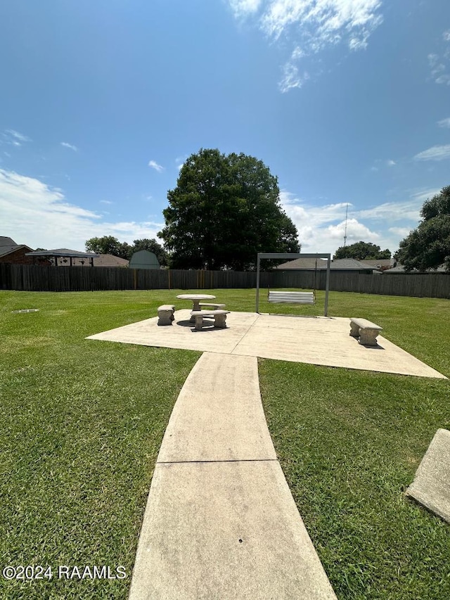 surrounding community featuring a fire pit, a patio area, and fence