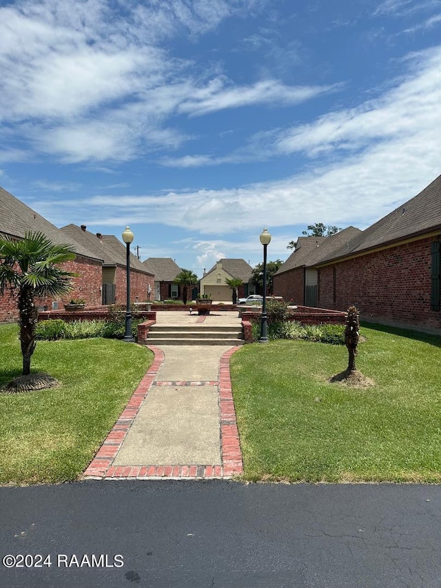 view of home's community featuring a lawn