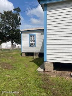 view of side of home with a yard