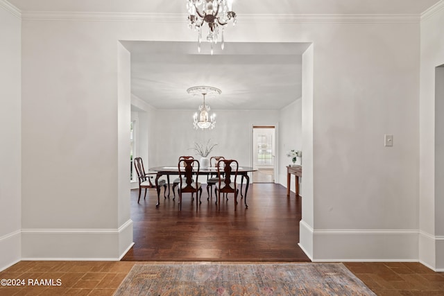 dining space with ornamental molding, an inviting chandelier, and dark hardwood / wood-style floors