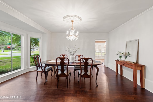 dining area with dark hardwood / wood-style flooring, an inviting chandelier, and ornamental molding