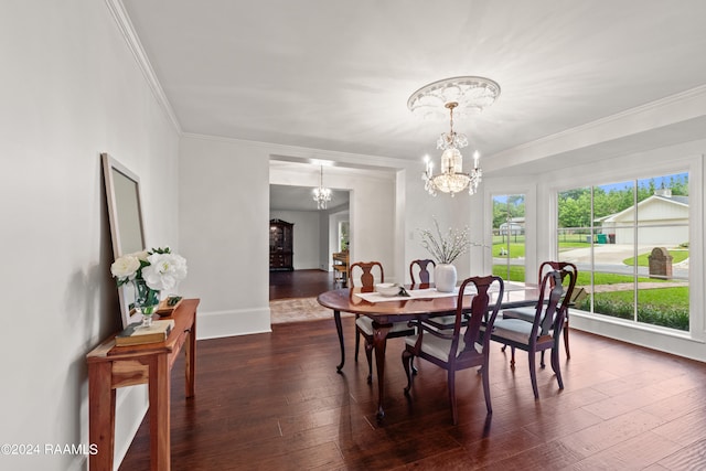 dining area with an inviting chandelier, dark wood-type flooring, and crown molding