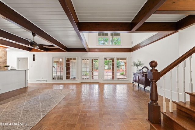 interior space with beamed ceiling and ceiling fan