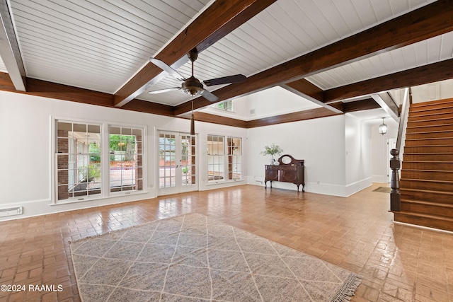 unfurnished living room with beam ceiling and ceiling fan