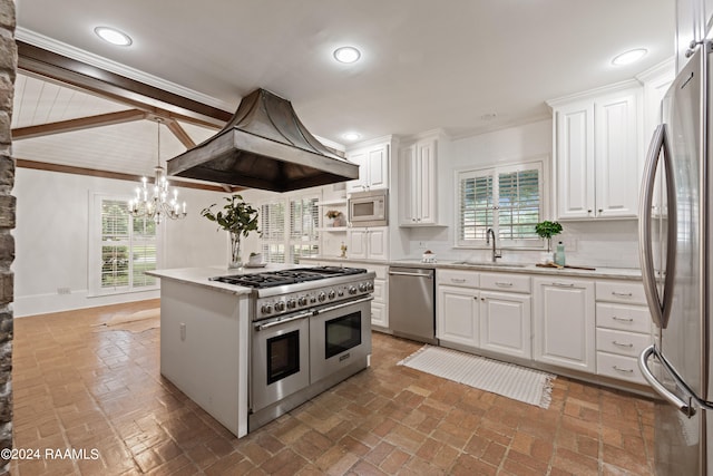 kitchen with backsplash, premium range hood, white cabinetry, and stainless steel appliances