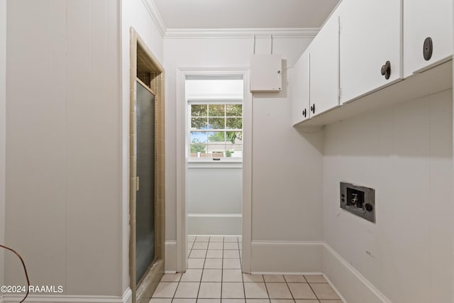 washroom with cabinets, light tile flooring, washer hookup, and ornamental molding