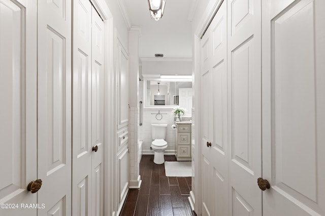 hall featuring ornamental molding and dark wood-type flooring