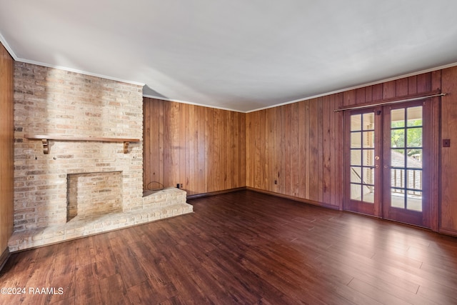 unfurnished living room with dark hardwood / wood-style floors and wooden walls