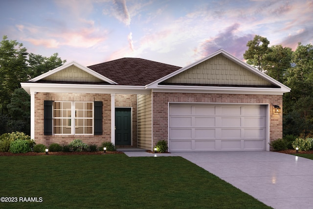 view of front of house featuring a garage and a lawn