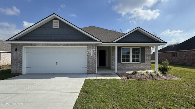 view of front of property with a front yard and a garage