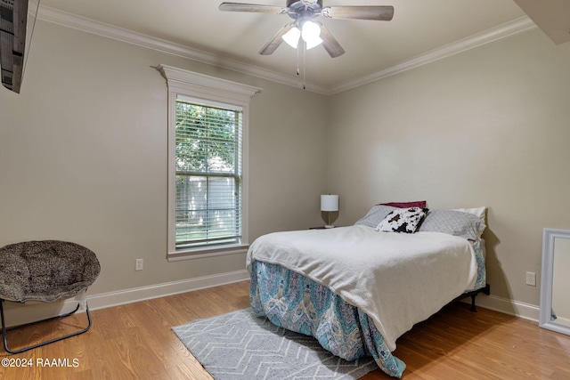 bedroom with ceiling fan, wood-type flooring, and ornamental molding