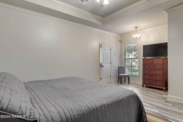 bedroom with crown molding, a chandelier, and light wood-type flooring