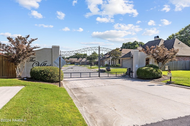 view of gate featuring a yard