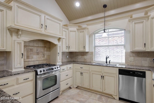 kitchen featuring vaulted ceiling, sink, stainless steel appliances, and cream cabinets