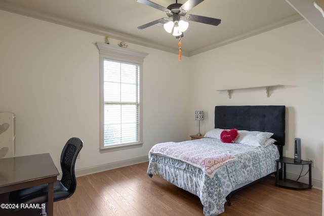 bedroom with hardwood / wood-style flooring, ceiling fan, and crown molding