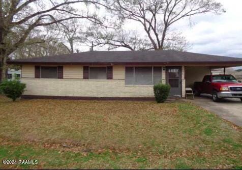 ranch-style home with a front yard and a carport