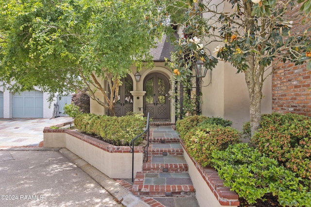 view of front of house featuring a garage and french doors