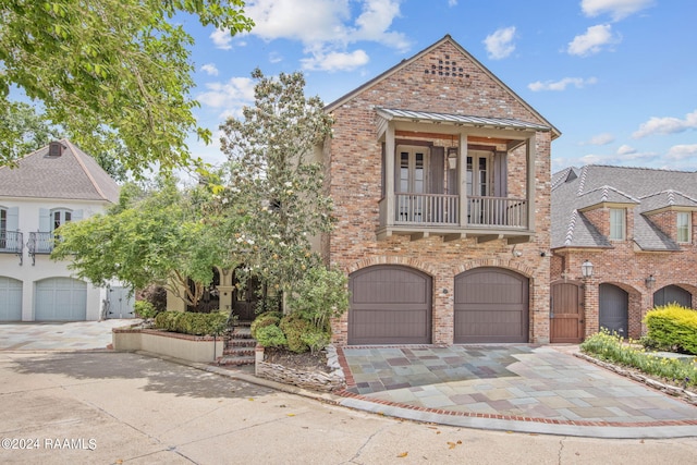 view of front of house with a garage and a balcony