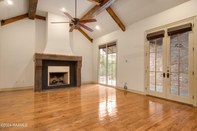 unfurnished living room with french doors, beam ceiling, light wood-type flooring, and ceiling fan