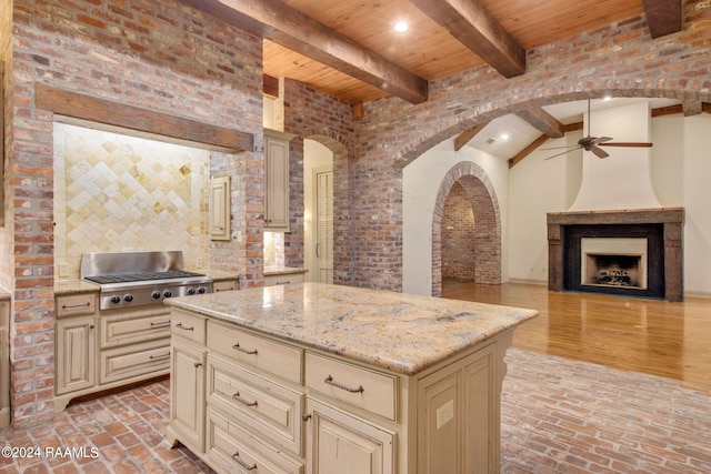 kitchen featuring cream cabinetry, ceiling fan, a kitchen island, and light wood-type flooring