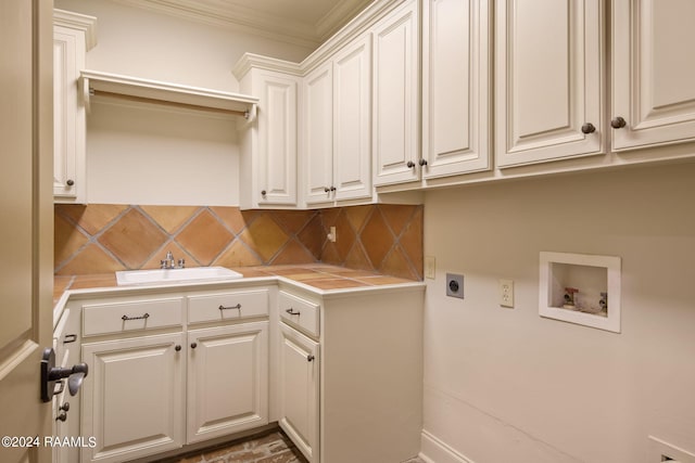 clothes washing area with sink, cabinets, hookup for an electric dryer, crown molding, and hookup for a washing machine