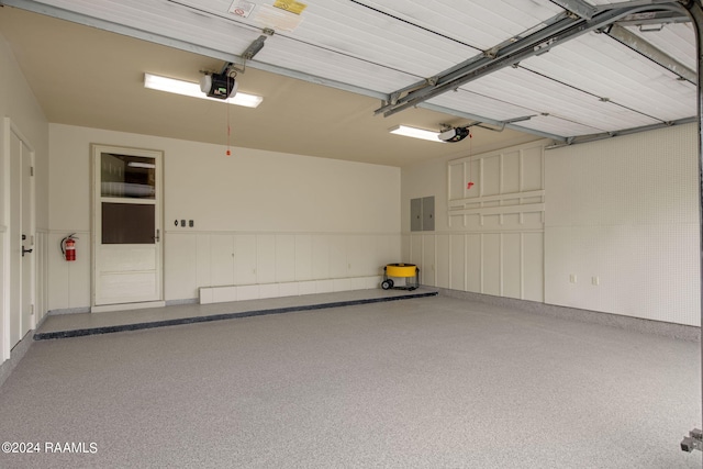 garage with electric panel and a garage door opener