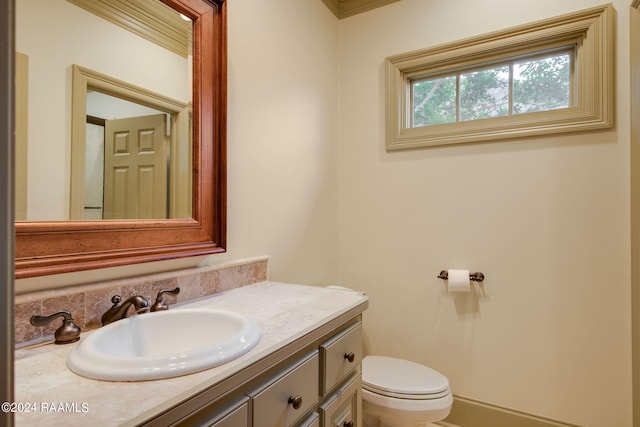 bathroom featuring vanity and toilet