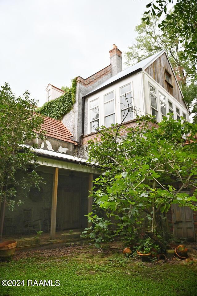 view of outdoor structure featuring a sunroom