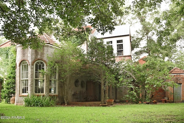 rear view of property featuring a yard