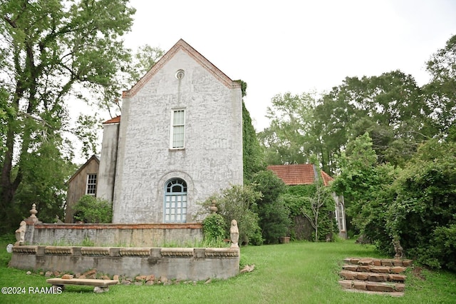 rear view of property with a yard