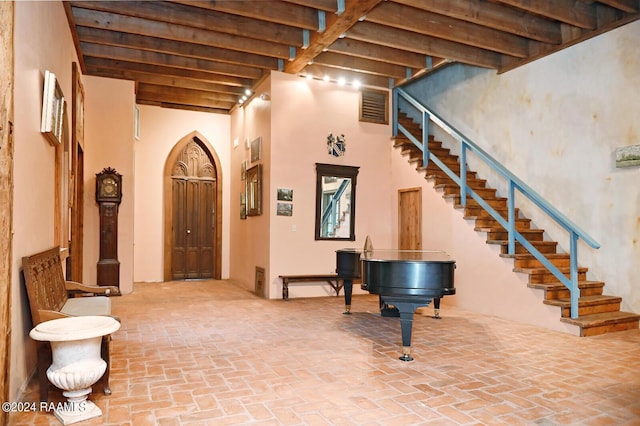 foyer entrance with beam ceiling