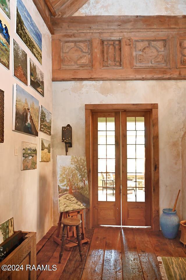 entryway featuring dark wood-type flooring and french doors