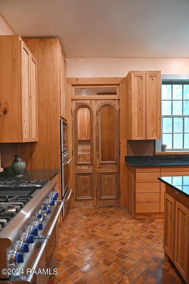 kitchen featuring stainless steel appliances and light brown cabinets