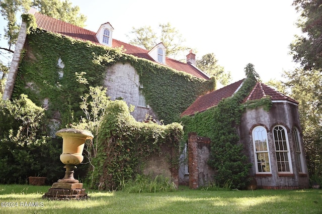 view of property exterior with a lawn