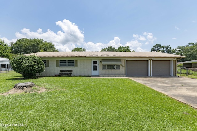 ranch-style house with a front yard and a garage