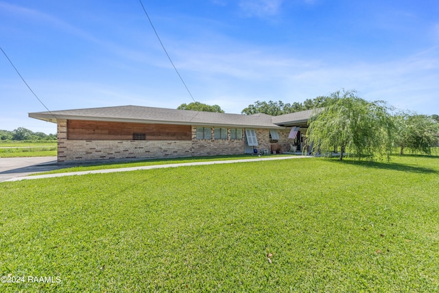 ranch-style house with a front lawn