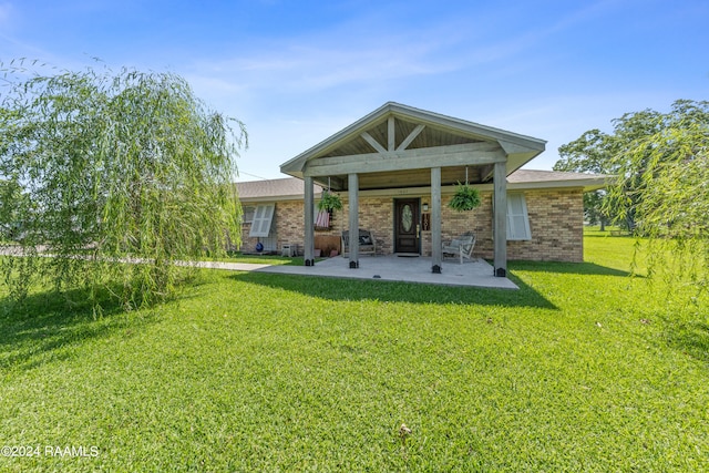 back of house featuring a yard and a patio