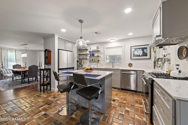 kitchen with gray cabinets, a healthy amount of sunlight, sink, and appliances with stainless steel finishes