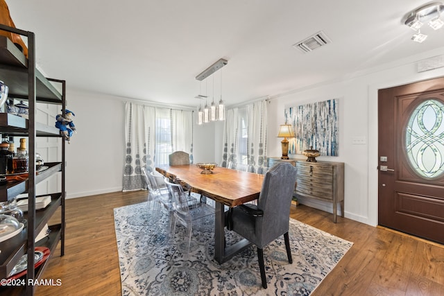 dining space with wood-type flooring and plenty of natural light