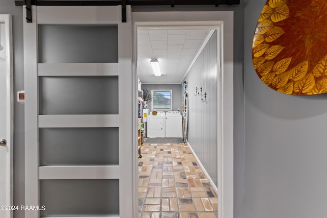 interior space with a barn door and washing machine and clothes dryer