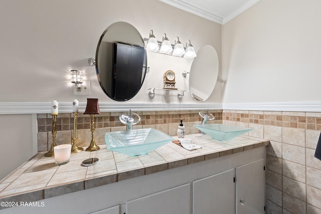 bathroom with vanity, tasteful backsplash, tile walls, and ornamental molding