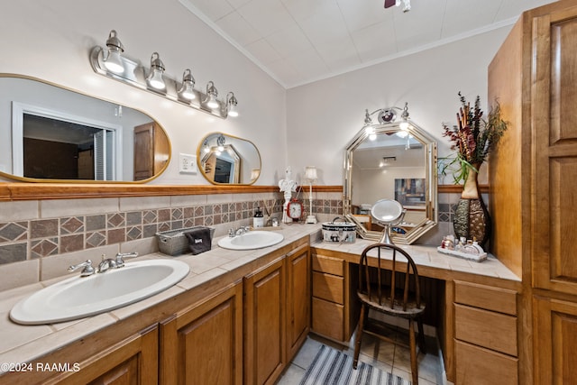 bathroom featuring dual sinks, tile flooring, backsplash, and large vanity