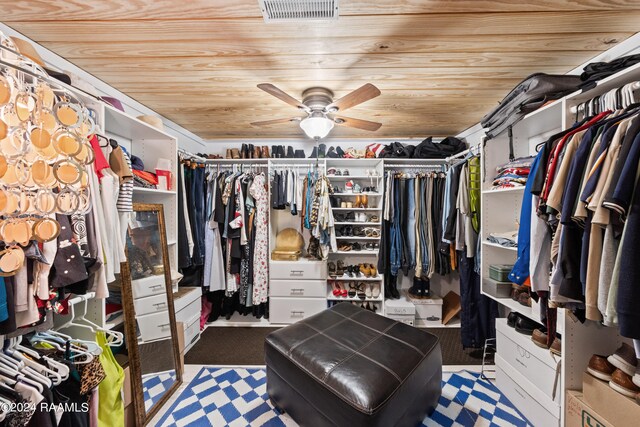 walk in closet featuring ceiling fan and carpet floors