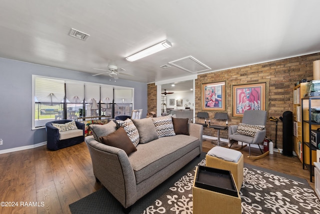 living room featuring brick wall, ceiling fan, and dark hardwood / wood-style floors