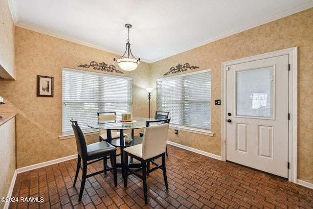 dining space with brick floor, wallpapered walls, baseboards, and crown molding