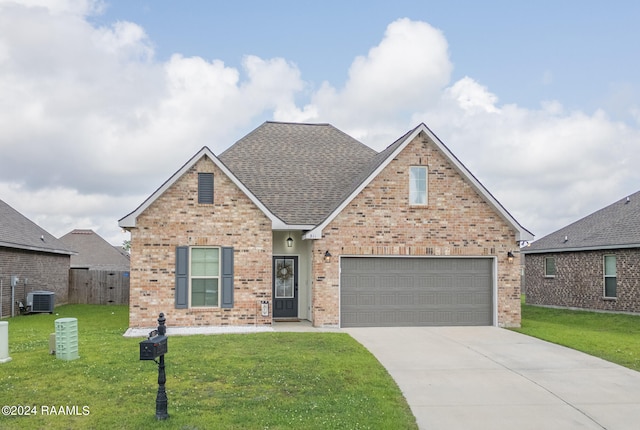 front of property featuring a garage, central AC, and a front lawn